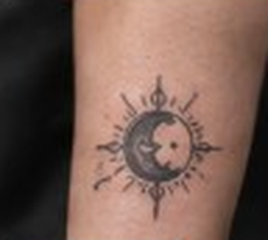 Simple sun and moon tattoo on an arm